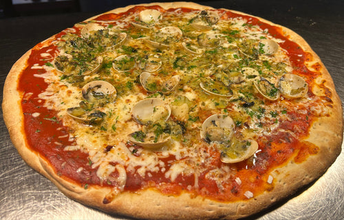 Pizza with various toppings on a metal surface