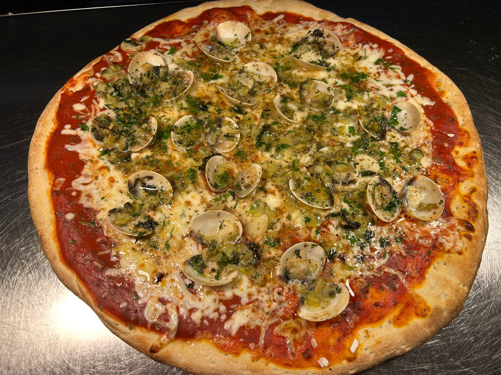 Pizza with mushrooms and herbs on a metal surface