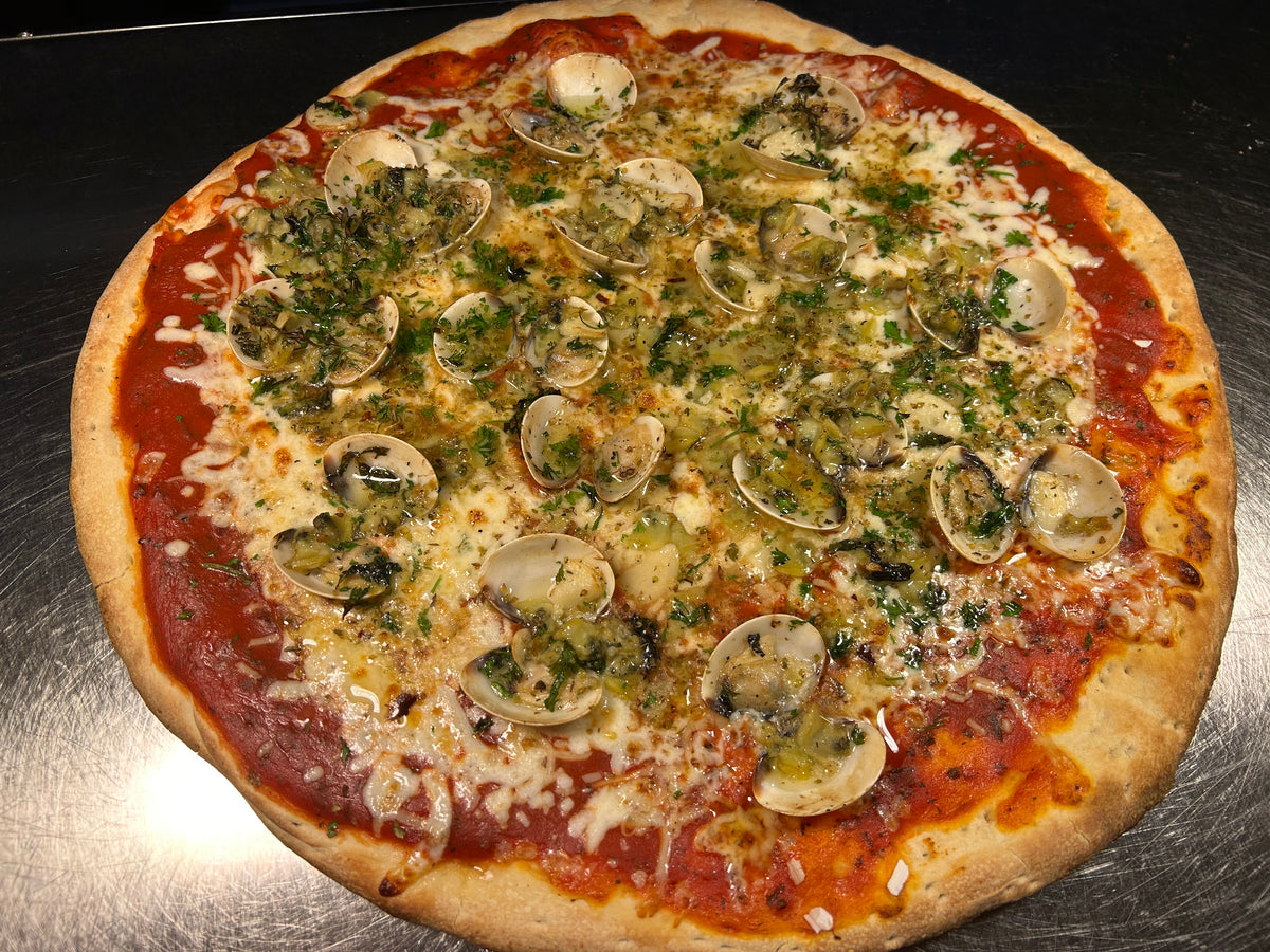 Pizza with mushrooms and herbs on a metal surface