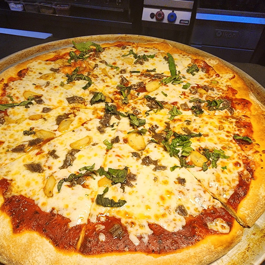 Cheesy pizza with spinach on a metal tray