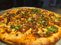 Close-up of a pizza with toppings on a metal tray