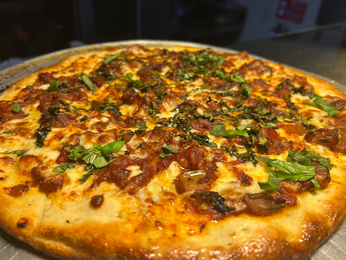 Close-up of a pizza with toppings on a metal tray