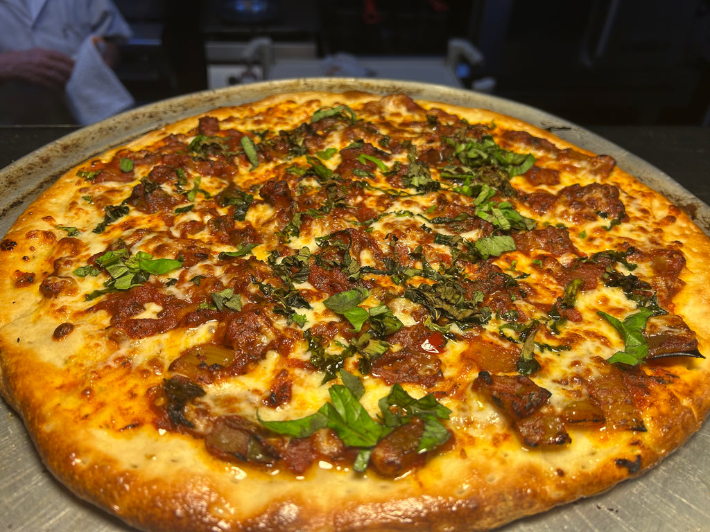 Pizza with various toppings on a metal tray