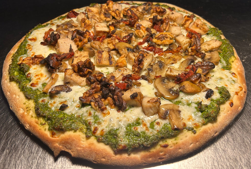 Pizza with various toppings on a metal surface