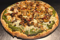 Pizza with various toppings on a metal surface