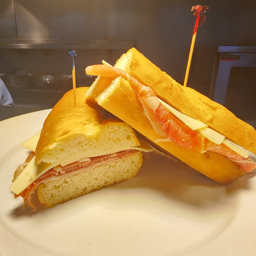 Two halves of a sandwich on a plate with a blurred background